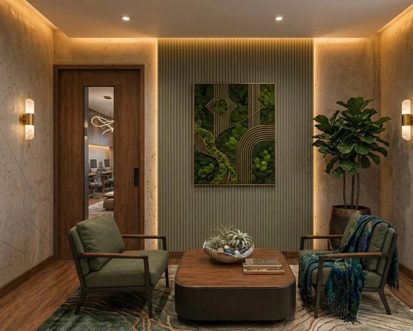 An office waiting area with two green upholstered armchairs around a wood coffee table, a preserved moss and brass wall panel on a fluted grey wall, a fiddle-leaf fig in a bronze planter and a wood door revealing a meeting room beyond.